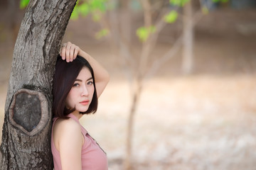 Portrait of beautiful asian woman in the park,Thailand people pose for take a picture,The hobby of girl single,Time for relax