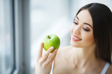 Woman With Apple. Beautiful Girl With White Smile, Healthy Teeth. High Resolution Image