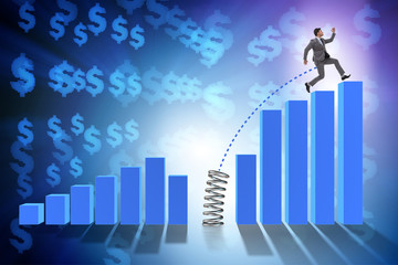 Business people jumping over bar charts