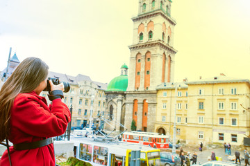 tourist woman taking picture of old european city. travel concept.