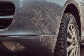 Close-up image of a dirty car after a trip around the countryside