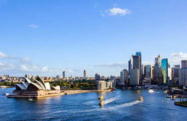 Sydney’s circular quay harbour with multiple ferries arriving and departing and the magnificent...