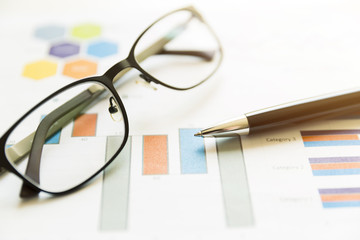 Preparing report. Graphs and charts. Business reports, glasses and pen. Business concept