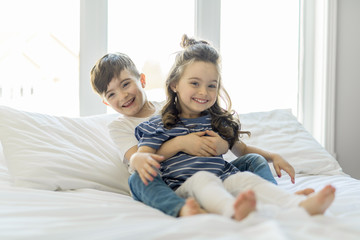 Fototapeta premium Brother And Sister having fun Together on Bed