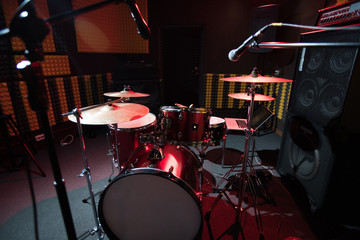 Fototapeta na wymiar Background of modern profession drum set in dark recording studio, copy space