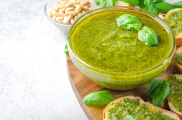 Pesto sauce and sliced bread on a stone table