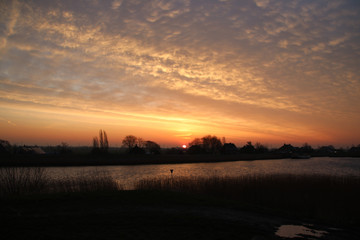 Obraz premium Sunrise over river Hollandse IJssel with colorful sky in the Netherlands