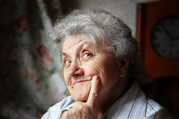 Smile and thoughtful elderly woman portrait