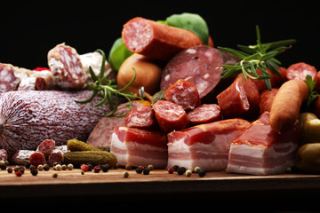 Food tray with delicious salami, ham,  fresh sausages, cucumber and herbs. Meat platter
