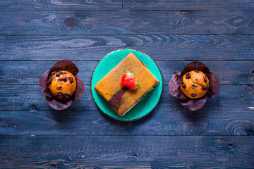 Fototapeta na wymiar Breakfast with different pastries and fruits on a wooden