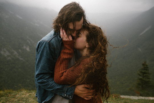 Couple Romantic Hugging on Top of A Windy Mountain