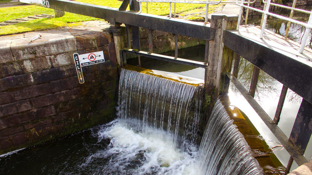 Water Flowing Over A Closed Canal Lock Gate.