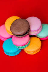 A delicious dessert of multicolored biscuits on a red background