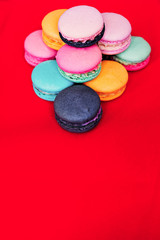 Fototapeta na wymiar red background on which lies delicious sweet biscuits of different colors