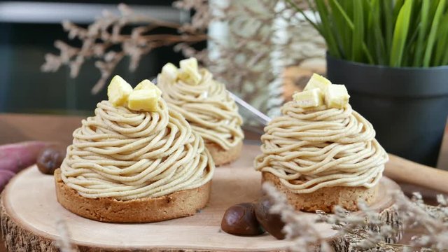 Mont Blanc Dessert or Chestnut Cream cake a dessert filled mostly with whipped cream. set on wooden table