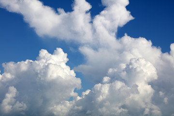 Fluffy white clouds in blue sky