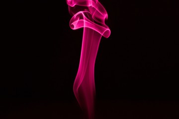 Colored smoke on black background.