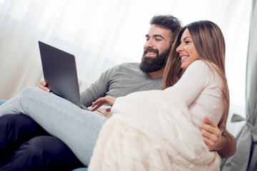 Young couple with laptop in the living room