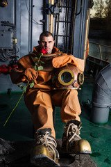 Vintage diver hold in hand red rose