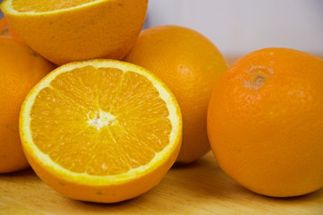 Several oranges and one cut in half
