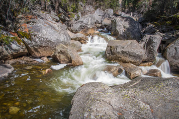 long exposure of rocky river from water fall at yosemite 