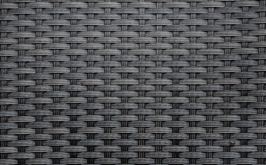 Black artificial rattan pattern. Background of basket structure close-up. Furniture backdrop - obrazy, fototapety, plakaty