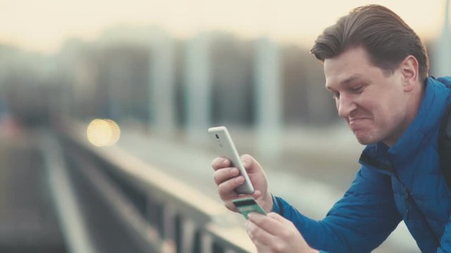 A man makes an online purchase using a smartphone.