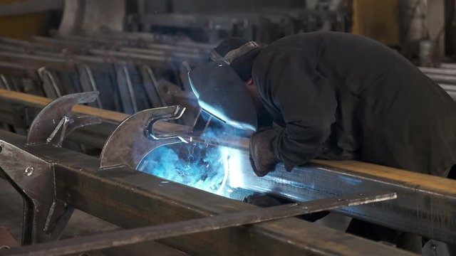 Welders working at the factory made metal. Slow motion