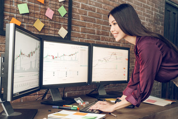 Woman analyzing data, graphs and reports for investment purposes.