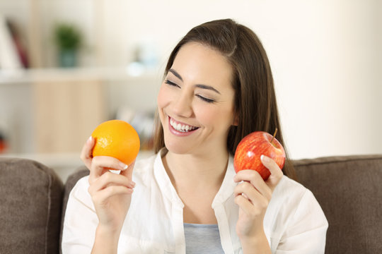 Woman deciding between different fruits