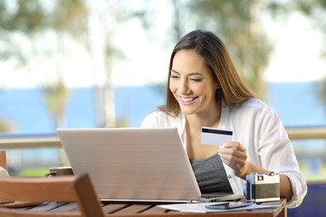 Tourist paying online with a credit card at hotel