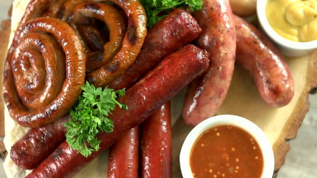 Cooked sausages with sauce. Grilled food top view.