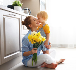 happy mother's day! baby son gives flowersfor  mother on holiday .