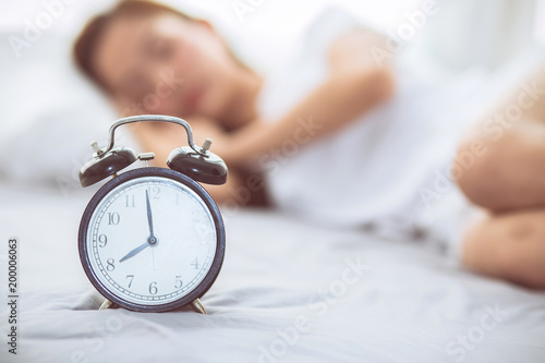 Beautiful Asian Young Woman Turn Off Alarm Clock In Good Morning Wake Up For Sleep With Closeup Foreground Alarm Clock Relax And Lifestyle Concept Beautiful Asian Young Woman Turn Off Alarm Clock In Good Morning Wake Up For Sleep With Closeup Foreground Alarm Clock Relax And Lifestyle Concept