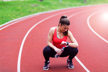 Female runner looking at smartwatch