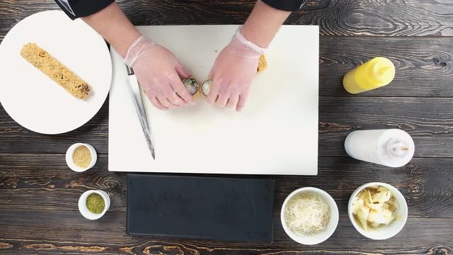Sushi on cutting board. Chef preparing unagi maki rolls.