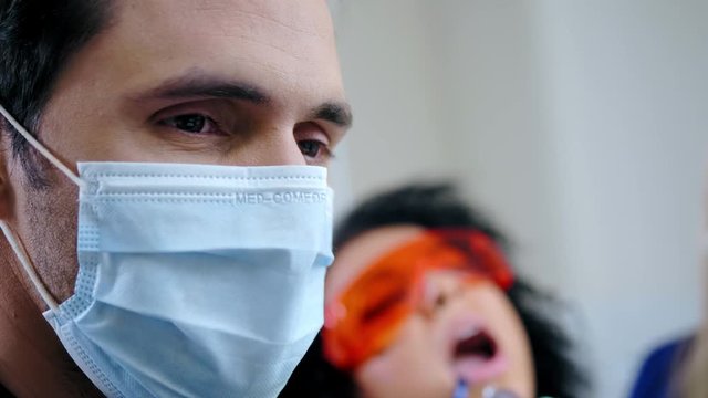 Dentist and his assitant working in private practice.