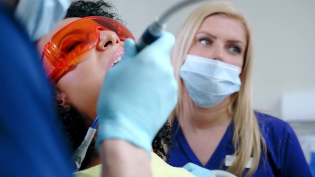 Dentist and his assitant working in private practice.