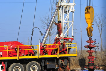 Fototapeta premium Oil field oil workers at work
