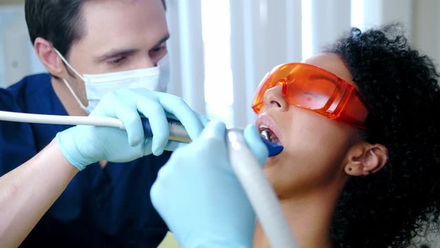 Dentist and his assitant working in private practice.