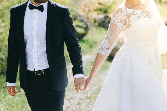 Wedding couple with bouquet female and male portrait beautiful model girl in white dress man in black