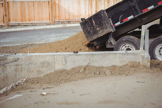 Dumper unloading mud at construction site