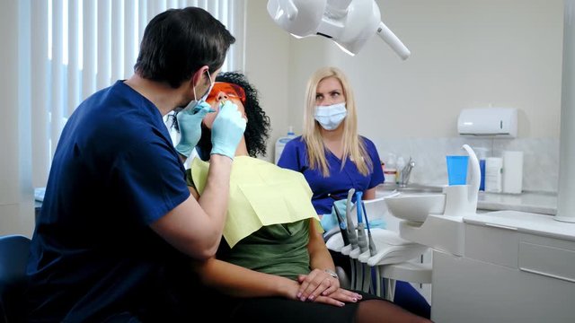 Dentist and his assitant working in private practice.