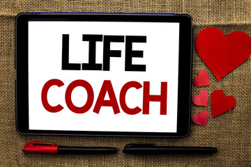 Handwriting text writing Life Coach. Concept meaning Mentoring Guiding Career Guidance Encourage Trainer Mentor written on Tablet on the jute background Hearts and Pens next to it.