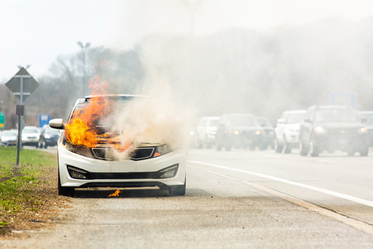 Burning car on fire on a highway road accident