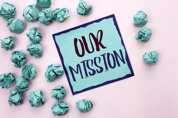 Conceptual hand writing showing Our Mission. Business photo text Goal Motivation Target Growth Planning Innovation Vision written on Sticky Note Paper on the light pink plain background.