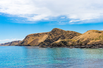 Mountain coastline with deep blue ocean water landscape