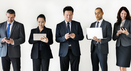 Business people busy on gadgets