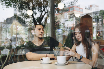 Lovely asian couple having coffee