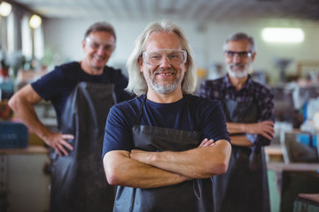 Portrait of smiling glassblowers